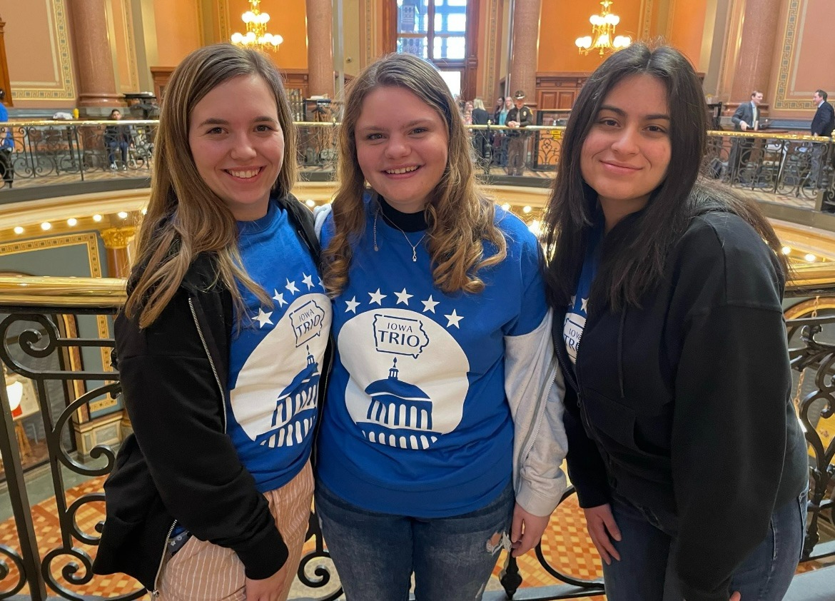 Three students pose for photo at the capitol