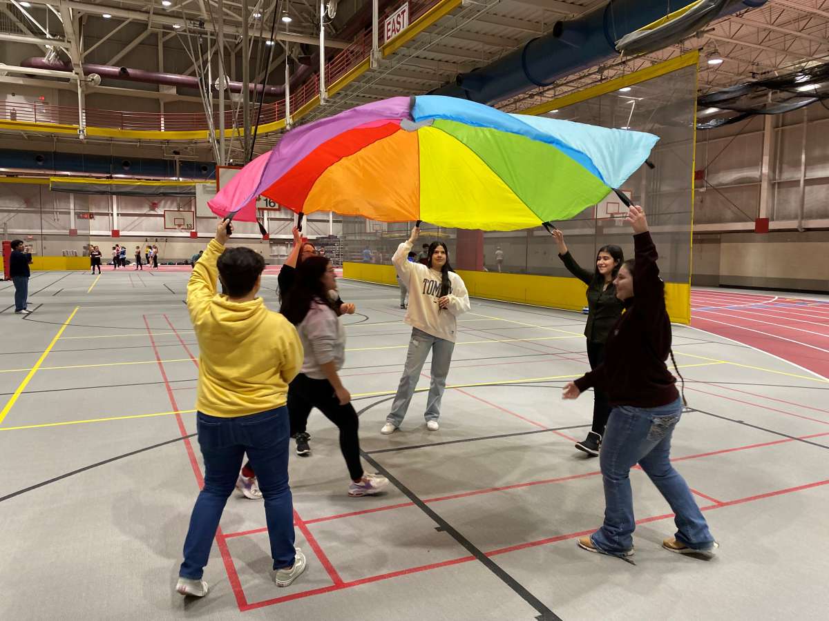 Students playing a parachute game 
